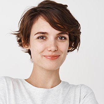 portrait of confident and happy woman with short hair, cross arms on chest like professional and smiling, standing against white background